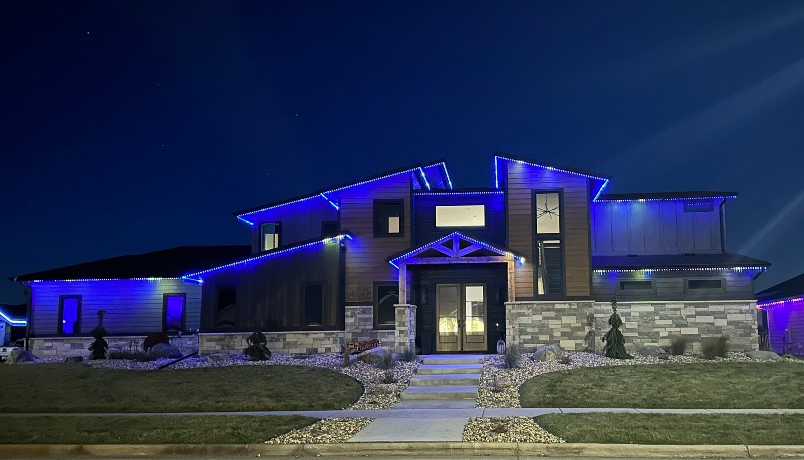 Permanent LED holiday lighting on a home in Sioux Falls at night